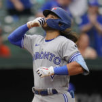 
              Toronto Blue Jays' Bo Bichette reacts after hitting a three-run home run off Baltimore Orioles relief pitcher Nick Vespi during the third inning of the second game of a baseball doubleheader, Monday, Sept. 5, 2022, in Baltimore. Blue Jays' Jackie Bradley Jr. and George Springer scored on the home run. (AP Photo/Julio Cortez)
            