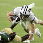 
              BYU wide receiver Chase Roberts, top, is brought down by South Florida defensive back TJ Robinson, bottom, during the second half of an NCAA college football game Saturday, Sept. 3, 2022, in Tampa, Fla. (AP Photo/Jason Behnken)
            