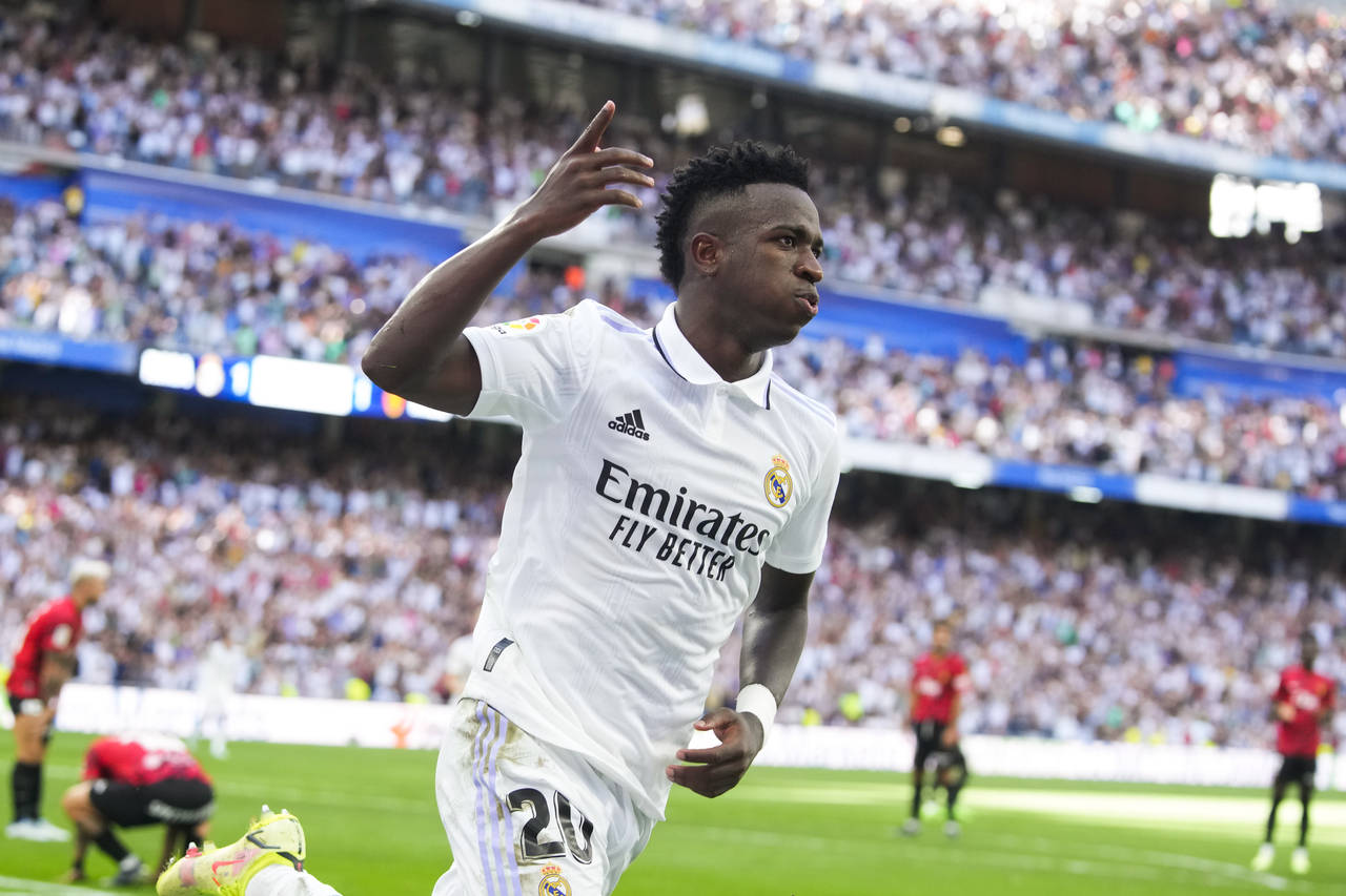 Real Madrid's Vinicius Junior, left, celebrates after scoring his side's 2nd goal during the Spanis...