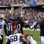 
              Houston Texans running back Dameon Pierce (31) celebrates with A.J. Cann (60) after rushing for a touchdown against the Chicago Bears during the first half of an NFL football game Sunday, Sept. 25, 2022, in Chicago. (AP Photo/Charles Rex Arbogast)
            