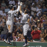 
              New York Yankees' Aaron Judge (99) celebrates his home run against the Boston Red Sox with Giancarlo Stanton, right, during the sixth inning of a baseball game Tuesday, Sept. 13, 2022, in Boston. (AP Photo/Steven Senne)
            