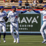 
              Los Angeles Dodgers' Cody Bellinger (35) celebrates with Trayce Thompson (25) and Miguel Vargas after the Dodgers defeated the Arizona Diamondbacks in a baseball game Tuesday, Sept. 20, 2022, in Los Angeles. (AP Photo/Ringo H.W. Chiu)
            