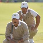 
              K.H. Lee, of South Korea, and Tom Kim, of South Korea, line up a putt on the 12th green during their foursomes match at the Presidents Cup golf tournament at the Quail Hollow Club, Saturday, Sept. 24, 2022, in Charlotte, N.C. (AP Photo/Chris Carlson)
            