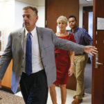 
              Former Texas Rangers pitcher John Wetteland, front, accused of sexually assaulting a child, alongside his wife, Rebecca, leaves the courtroom during the final day of his trial at the Denton County Courthouse in Denton, Texas, Friday, Sept. 2, 2022. The judge declared a mistrial after the jury said they were deadlocked. (Shafkat Anowar/The Dallas Morning News via AP)
            