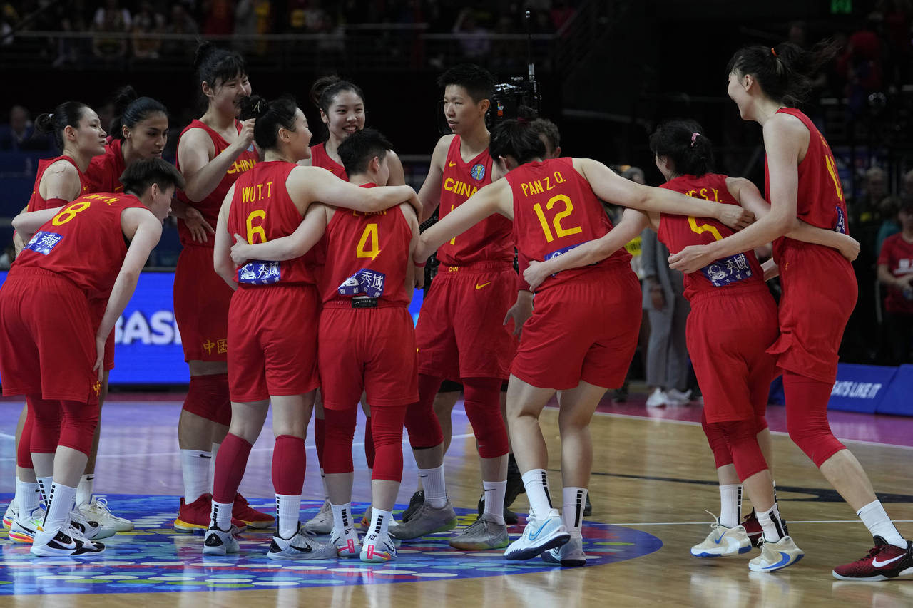 China's players celebrate their win over Australia in their semifinal game at the women's Basketbal...