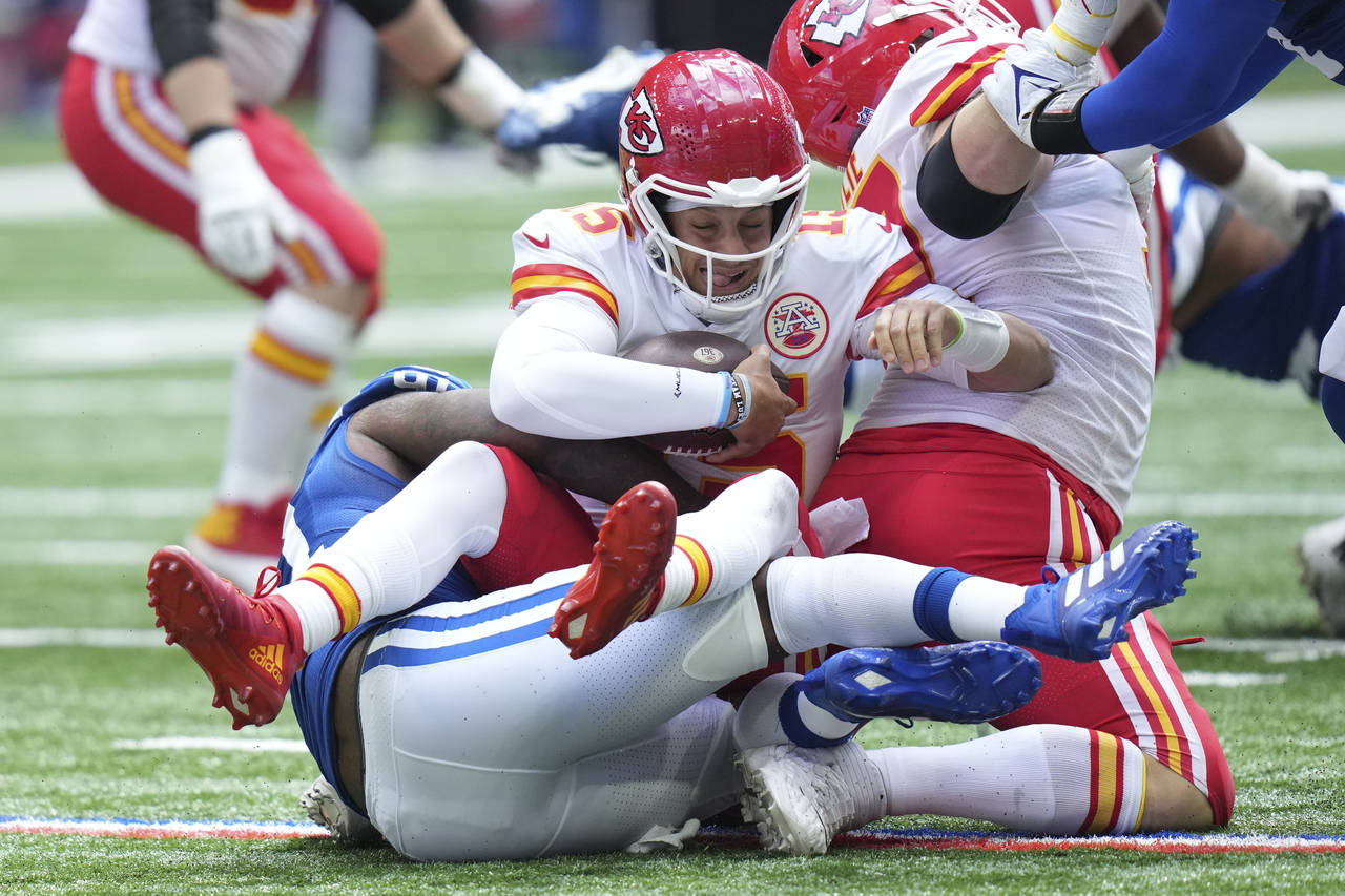 Kansas City Chiefs quarterback Patrick Mahomes (15) is sacked by Indianapolis Colts defensive end Y...