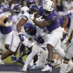 
              TCU running back Kendre Miller (33) scores a touchdown against Tarleton State defensive back Josh Kemp (16) during the first half of an NCAA college football game in Fort Worth, Texas, Saturday, Sept. 10, 2022. (AP Photo/LM Otero)
            