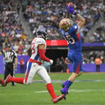 
              FILE - NFC tight end George Kittle, right, of the San Francisco 49ers, catches a pass in front of AFC outside linebacker Harold Landry, left, of the Tennessee Titans, during the first half of the Pro Bowl NFL football game, Sunday, Feb. 6, 2022, in Las Vegas.   The NFL is replacing the Pro Bowl with weeklong skills competitions and a flag football game. The new event will be renamed “The Pro Bowl Games” and will feature AFC and NFC players showcasing their football and non-football skills in challenges over several days.  (AP Photo/David Becker, File)
            