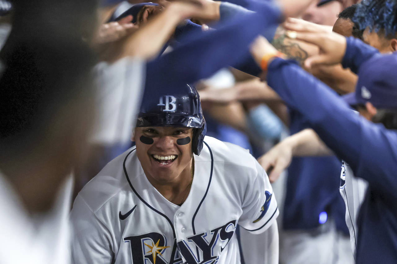 Tampa Bay Rays' Yu Chang celebrates in the dugout after hitting a home run against the Boston Red S...