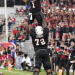 
              Houston wide receiver Nathaniel Dell (1) and offensive lineman Tank Jenkins (72) celebrate Dell's 1-yard touchdown reception against Tulane during the second quarter of an NCAA college football game Friday, Sept. 30, 2022, in Houston. (Brett Coomer/Houston Chronicle via AP)
            