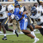 
              Duke's Jordan Moore (8) carries the ball ahead of North Carolina A&T's Janaz Sumpter (9), Henry Daniel (34), and Ty Williams Jr. (26) during the first half of an NCAA college football game in Durham, N.C., Saturday, Sept. 17, 2022. (AP Photo/Ben McKeown)
            