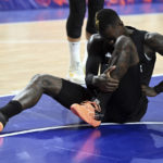 
              Germany's Dennis Schroeder sits on the ground after a foul during the Eurobasket, preliminary round, Group B match between Lithuania and Germany in Cologne, Germany, Sunday, Sept. 4, 2022. (Federica Gambarini/dpa via AP)
            