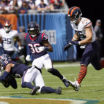 
              Houston Texans safety Jalen Pitre (5) intercepts a pass in front of Chicago Bears tight end Cole Kmet (85) during the first half of an NFL football game Sunday, Sept. 25, 2022, in Chicago. (AP Photo/Charles Rex Arbogast)
            