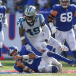 
              New York Giants quarterback Daniel Jones, bottom, slides after running for a first down during the second half an NFL football game against the Carolina Panthers, Sunday, Sept. 18, 2022, in East Rutherford, N.J. (AP Photo/John Munson)
            