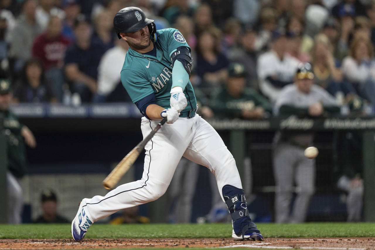 Seattle Mariners' Ty France hits an RBI double off Oakland Athletics starting pitcher Ken Waldichuk...