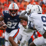 
              Auburn running back Jarquez Hunter (27) carries the ball as he tries to get past Penn State cornerback Joey Porter Jr. (9) during the first half of an NCAA college football game, Saturday, Sept. 17, 2022, in Auburn, Ala. (AP Photo/Butch Dill)
            