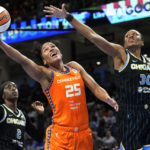 
              Connecticut Sun's Alyssa Thomas (25) shoots as Chicago Sky's Azura Stevens, right, defends, and Kahleah Copper watches during the first half of Game 2 in a WNBA basketball playoffs semifinal Wednesday, Aug. 31, 2022, in Chicago. (AP Photo/Nam Y. Huh)
            