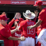 
              Los Angeles Angels' interim manager Phil Nevin, second from left, and teammates congratulate Livan Soto (13) for hitting a two-run home run during the seventh inning of a baseball game against the Seattle Mariners in Anaheim, Calif., Sunday, Sept. 18, 2022. (AP Photo/Alex Gallardo)
            
