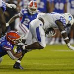 
              Kentucky running back Kavosiey Smoke, right, is tackled by Florida linebacker Ventrell Miller (51) during the first half of an NCAA college football game, Saturday, Sept. 10, 2022, in Gainesville, Fla. (AP Photo/John Raoux)
            