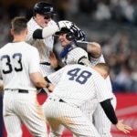
              New York Yankees' Josh Donaldson celebrates with teammates Harrison Bader (22),, Anthony Rizzo (48) and Tim Locastro (33) after hitting a walk-off RBI single during the tenth inning of a baseball game against the Boston Red Sox Thursday, Sept. 22, 2022, in New York. The Yankees won 5-4. (AP Photo/Frank Franklin II)
            