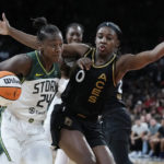 
              Seattle Storm guard Jewell Loyd (24) drives into Las Vegas Aces guard Jackie Young (0) during the second half in Game 2 of a WNBA basketball semifinal playoff series Wednesday, Aug. 31, 2022, in Las Vegas. (AP Photo/John Locher)
            