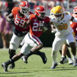 
              Georgia running back Branson Robinson (22) runs past Kent State defensive lineman Stephen Daley (90) in the first half of an NCAA college football game Saturday, Sept. 24, 2022, in Athens, Ga. (AP Photo/John Bazemore)
            