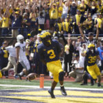 
              Michigan's A.J. Henning (3) celebrates his punt return for a 61-yard touchdown against Connecticut in the first half of an NCAA college football game in Ann Arbor, Mich., Saturday, Sept. 17, 2022. (AP Photo/Paul Sancya)
            