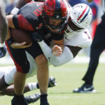 
              San Diego State's Braxton Burmeister, left, is tackled by Arizona's Jalen Harris in the first quarter of an NCAA college football game Saturday, Sept. 3, 2022, in San Diego, Calif. (K.C. Alfred/The San Diego Union-Tribune via AP)
            