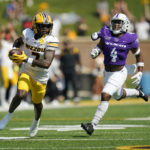 
              Missouri wide receiver Dominic Lovett, left, heads for the end zone after catching a 79-yard pass for a touchdown as Abilene Christian defensive back Anthony Egbo Jr. (4) defends during the first half of an NCAA college football game Saturday, Sept. 17, 2022, in Columbia, Mo. (AP Photo/Jeff Roberson)
            