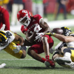 
              Rutgers wide receiver Joshua Youngblood (12) fumbles the ball after a hit from Iowa linebacker Jack Campbell, right, and defensive back Sebastian Castro (29), during the first half of an NCAA football game, Saturday, Sept. 24, 2022, in Piscataway, N.J.(AP Photo/Noah K. Murray)
            