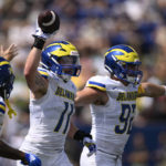 
              Delaware linebacker Liam Trainer (11) celebrates after he recovered a fumble during the first half of an NCAA college football game against Navy, Saturday, Sept. 3, 2022, in Annapolis, Md. Delaware defensive end Tommy Walsh (92) is at right. (AP Photo/Nick Wass)
            