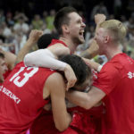 
              Poland's Mateusz Ponitka, center, and his teammates celebrate after the Eurobasket quarter final basketball match between Slovenia and Poland in Berlin, Germany, Wednesday, Sept. 14, 2022. Poland defeated Slovenia by 90-87. (AP Photo/Michael Sohn)
            
