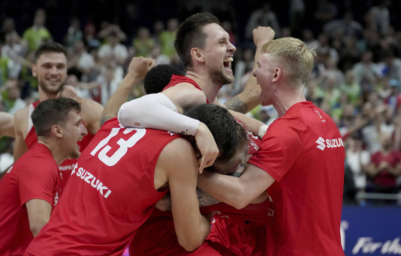 Poland's Mateusz Ponitka, center, and his teammates celebrate after the Eurobasket quarter final ba...