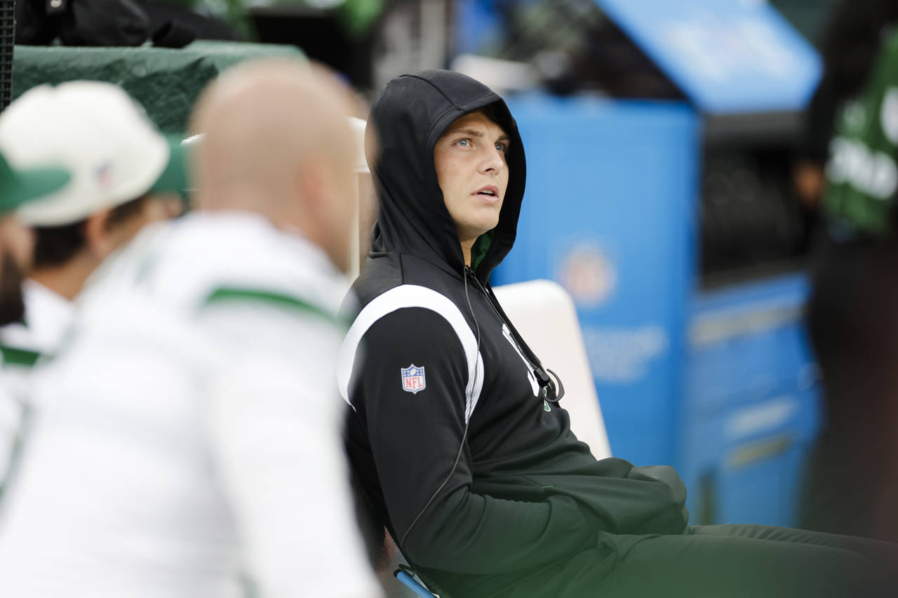 New York Jets quarterback Zach Wilson reacts during the second half of an NFL football game against...