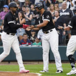 
              Chicago White Sox's Eloy Jimenez, left, celebrates with Jose Abreu, center, and Andrew Vaughn after hitting a three-run home run during the first inning of a baseball game against the Minnesota Twins in Chicago, Saturday, Sept. 3, 2022. (AP Photo/Nam Y. Huh)
            