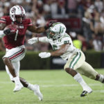 
              South Carolina running back MarShawn Lloyd (1) fends off Charlotte defensive back Solomon Rogers (6) during the first half of an NCAA college football game Saturday, Sept. 24, 2022, in Columbia, S.C. (AP Photo/Artie Walker Jr.)
            