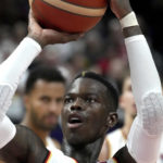 
              Germany's Dennis Schroeder plays the ball during the Eurobasket third place basketball match between Germany and Poland in Berlin, Germany, Sunday, Sept. 18, 2022. (AP Photo/Michael Sohn)
            