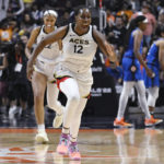 
              Las Vegas Aces' Chelsea Gray (12) celebrates with her team their win in the WNBA basketball finals against the Connecticut Sun, Sunday, Sept. 18, 2022, in Uncasville, Conn. (AP Photo/Jessica Hill)
            