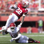 
              Nebraska's Gabe Ervin Jr. (22) gets tripped up by Oklahoma's Key Lawrence (12) during the second half of an NCAA college football game Saturday, Sept. 17, 2022, in Lincoln, Neb. Oklahoma won 49-14. (AP Photo/Rebecca S. Gratz)
            