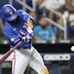 
              Texas Rangers' Marcus Semien hits a two run home run in the fifth inning during Game 2 of a doubleheader baseball game against the Miami Marlins, Monday, Sept. 12, 2022, in Miami. (AP Photo/Lynne Sladky)
            