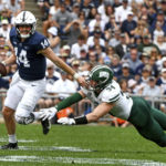 
              Penn State quarterback Sean Clifford (14) scrambles away from Ohio linebacker Dylan Stevens (34) in the first half of an NCAA college football game, Saturday, Sept. 10, 2022, in State College, Pa. (AP Photo/Barry Reeger)
            