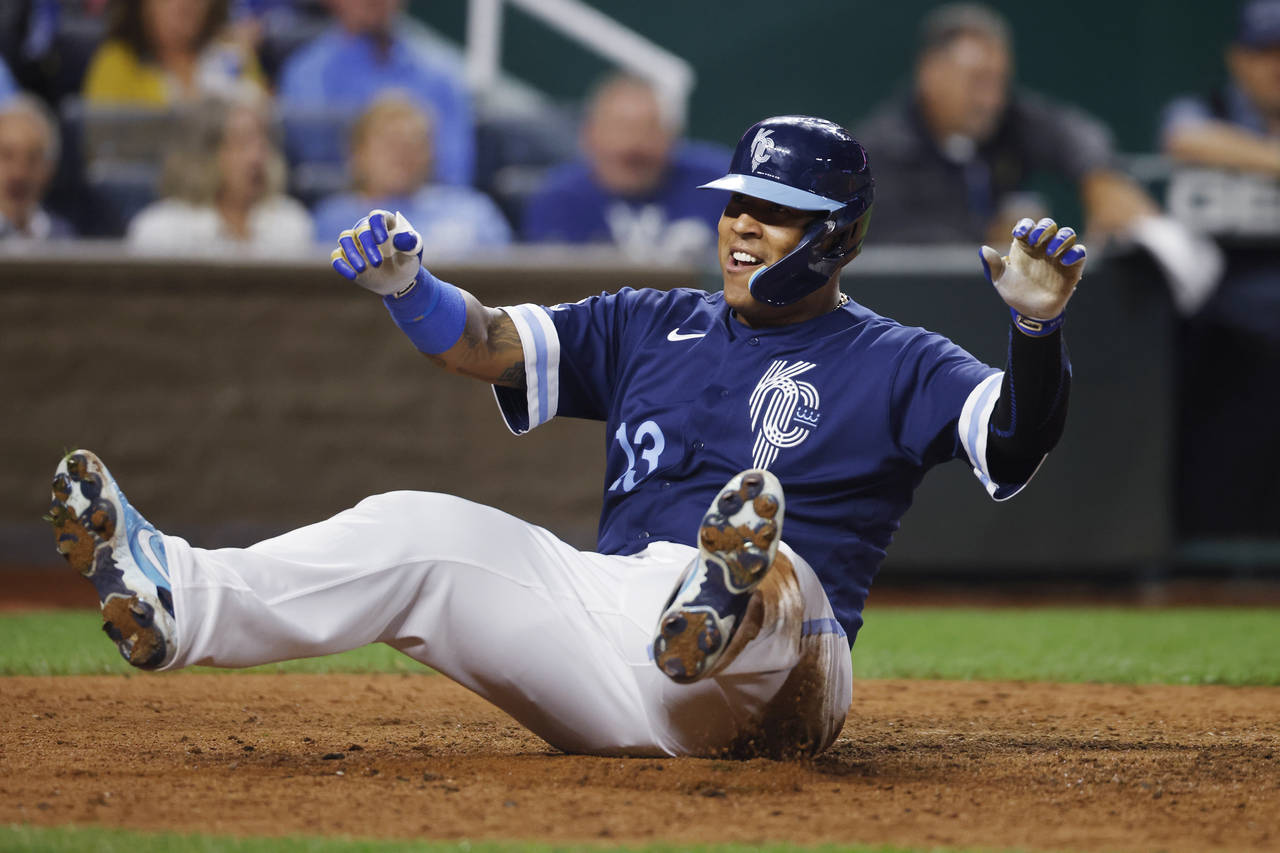 Kansas City Royals' Salvador Perez reacts after scoring from second off a Vinnie Pasquantino single...
