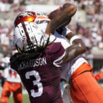 
              Bowling Green wide receiver Tyrone Broden (0) holds on to a 25-yard touchdown reception pass while Mississippi State cornerback Decamerion Richardson (3) attempts to strip the ball away during the first half of an NCAA college football game in Starkville, Miss., Saturday, Sept. 24, 2022. (AP Photo/Rogelio V. Solis)
            
