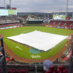 
              Grounds crew members lay a tarp over the infield prior to a baseball game between the Colorado Rockies and the Cincinnati Reds, Saturday, Sept. 3, 2022, in Cincinnati. (AP Photo/Jeff Dean)
            