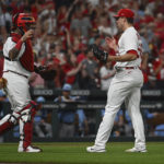 
              St. Louis Cardinals catcher Yadier Molina, left, and pitcher Ryan Helsley celebrate the Cardinals' 4-1 victory over the Milwaukee Brewers in a baseball game on Wednesday Sept. 14, 2022, in St. Louis. (AP Photo/Joe Puetz)
            