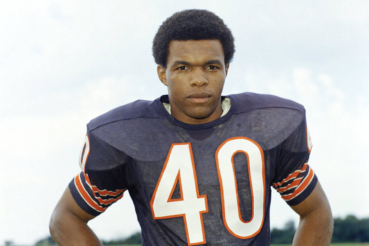 FILE - Chicago Bears football player Gale Sayers poses for a photo in 1970. There is a fine line be...