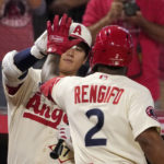 
              Los Angeles Angels' Luis Rengifo, right, is congratulated by Shohei Ohtani after hitting a solo home run during the first inning of a baseball game Thursday, Sept. 29, 2022, in Anaheim, Calif. (AP Photo/Mark J. Terrill)
            