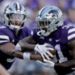 
              Kansas State quarterback Adrian Martinez, left, fakes a handoff to running back DJ Giddens (31) before running the ball for a touchdown during the first half of an NCAA college football game against South Dakota Saturday, Sept. 3, 2022, in Manhattan, Kan. (AP Photo/Charlie Riedel)
            
