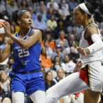 
              Connecticut Sun's Alyssa Thomas, left, looks to pass while Las Vegas Aces' A'ja Wilson defends during the first half in Game 3 of a WNBA basketball final playoff series, Thursday, Sept. 15, 2022, in Uncasville, Conn. (AP Photo/Jessica Hill)
            