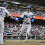 
              Los Angeles Dodgers' Trea Turner is congratulated by Justin Turner after he scored against the San Francisco Giants during the sixth inning of a baseball game in San Francisco, Sunday Sept. 18, 2022. (AP Photo/John Hefti)
            